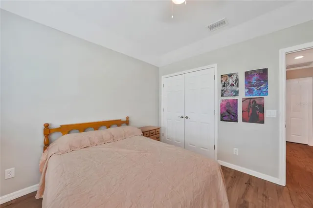 a bedroom with a bed and a lamp on the dresser