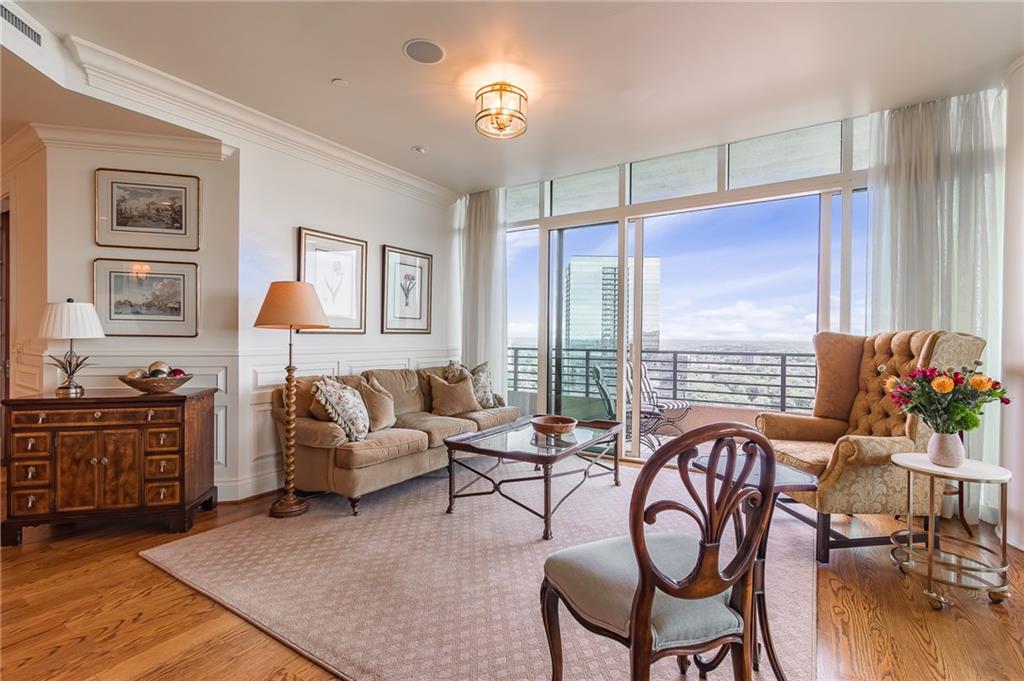 750 Park Avenue Northeast, Unit 29S Atlanta, GA 30326 - Photo 12 of 46 a living room with furniture large window and wooden floor
