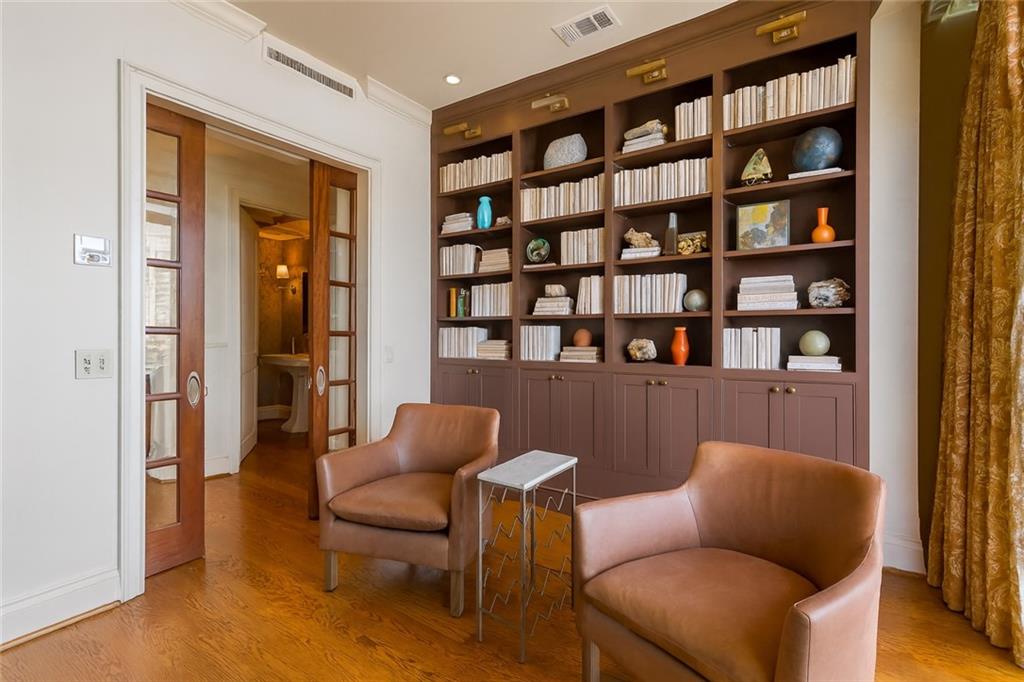 750 Park Avenue Northeast, Unit 29S Atlanta, GA 30326 - Photo 16 of 46 a living room with furniture and a book shelf