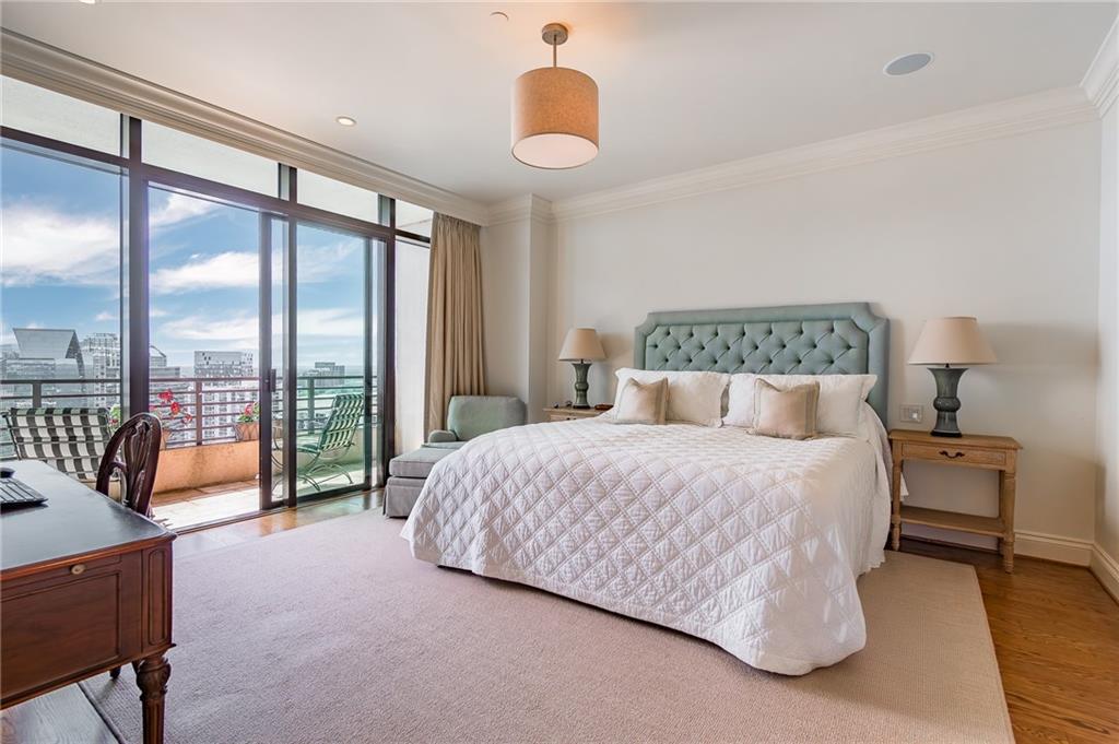 750 Park Avenue Northeast, Unit 29S Atlanta, GA 30326 - Photo 24 of 46 a bedroom with a bed and a lamp next to a large window