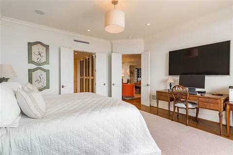 a bedroom with furniture and a flat screen tv