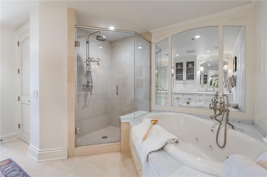 750 Park Avenue Northeast, Unit 29S Atlanta, GA 30326 - Photo 28 of 46 a bathroom with a tub and a shower