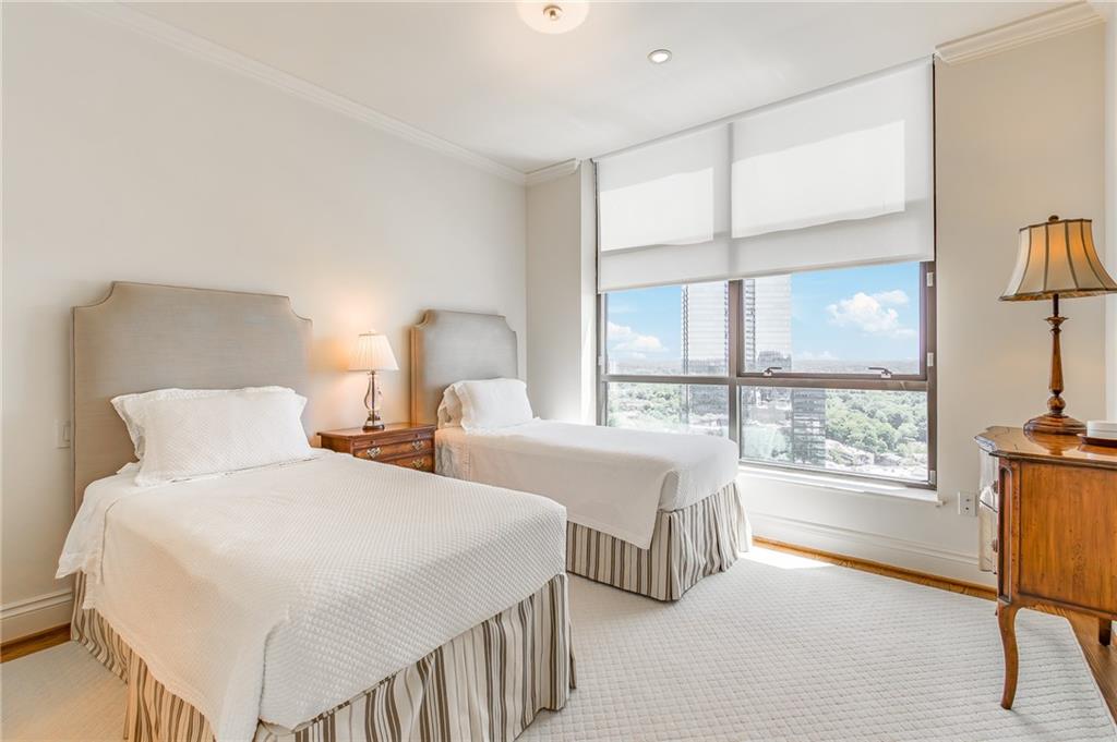 750 Park Avenue Northeast, Unit 29S Atlanta, GA 30326 - Photo 30 of 46 a bedroom with two beds and a large window