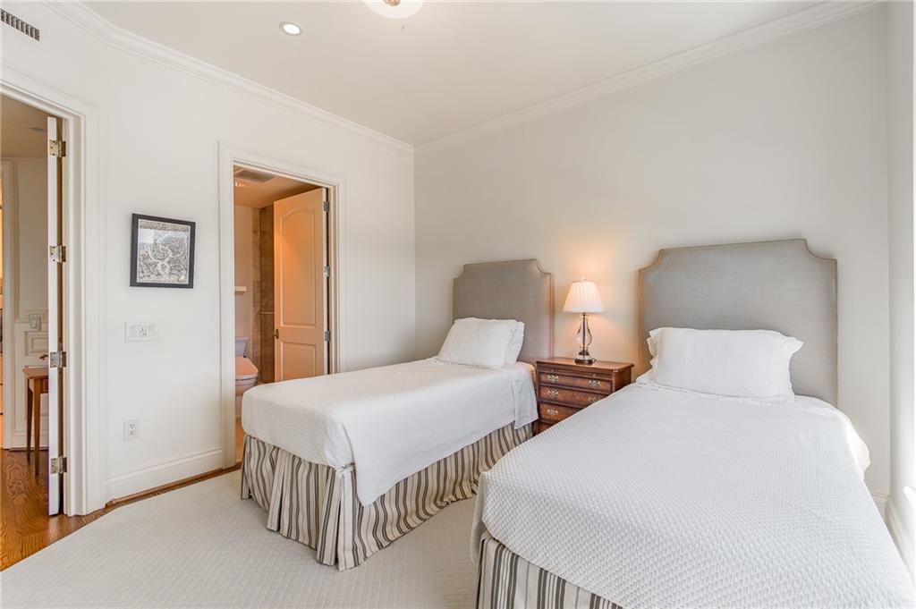 750 Park Avenue Northeast, Unit 29S Atlanta, GA 30326 - Photo 31 of 46 a bedroom with two beds and lamp