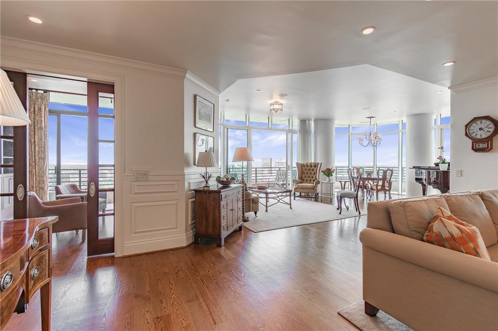 750 Park Avenue Northeast, Unit 29S Atlanta, GA 30326 - Photo 4 of 46 a living room with couches and kitchen view with wooden floor