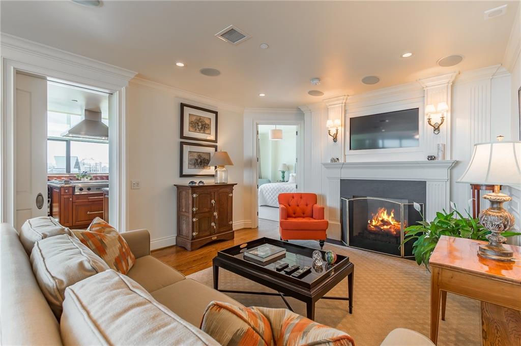 750 Park Avenue Northeast, Unit 29S Atlanta, GA 30326 - Photo 6 of 46 a living room with furniture a fireplace and a flat screen tv