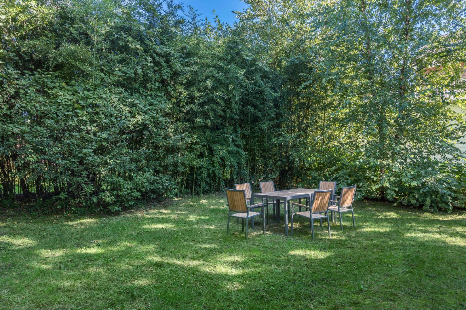 1 Sherrill Road East Hampton, NY 11937 - Photo 13 of 14 a view of a wooden bench sitting in the grass