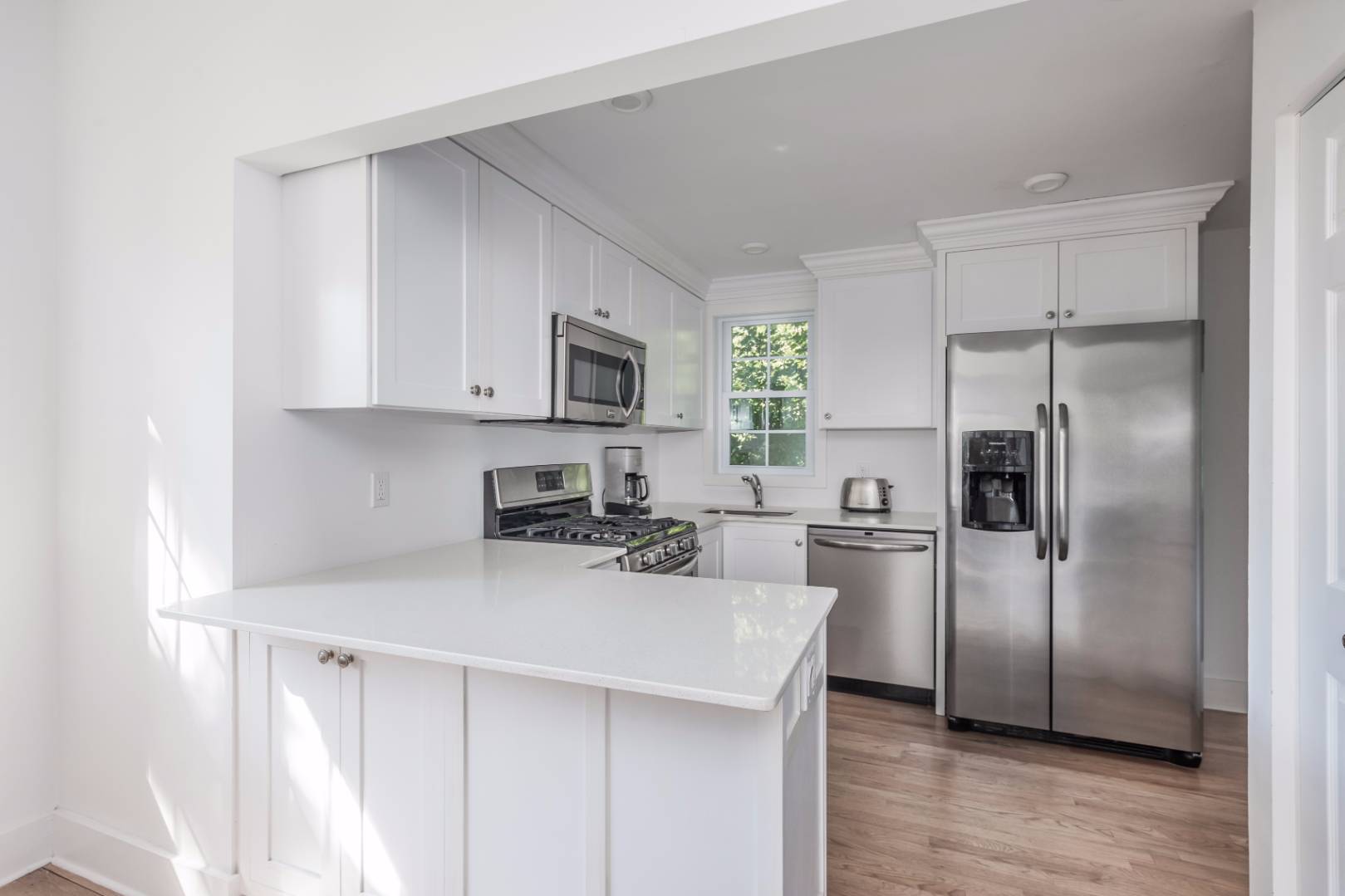1 Sherrill Road East Hampton, NY 11937 - Photo 8 of 14 a kitchen with a refrigerator a microwave a sink and cabinets