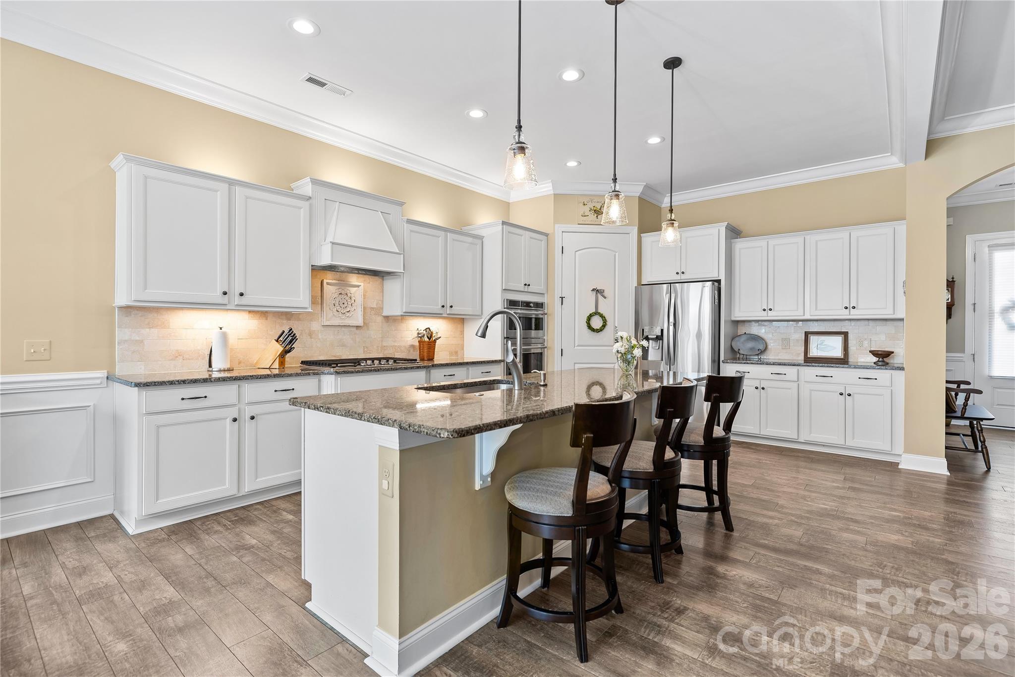 1106 Castle Road Fort Mill, SC 29707 - Photo 14 of 44 a kitchen with kitchen island granite countertop a table and chairs in it