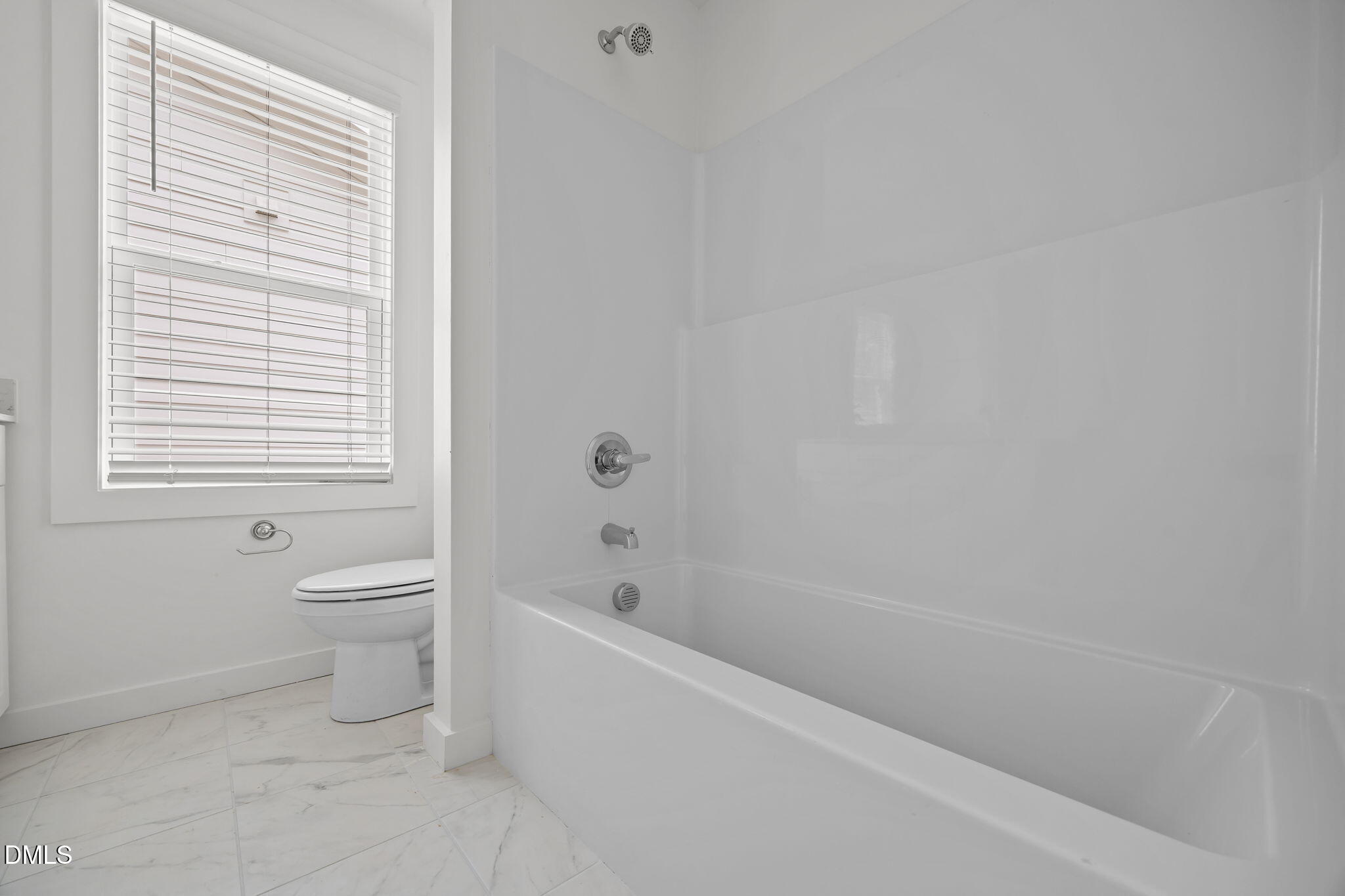 2811 Wilcox Street, Unit 103 Raleigh, NC 27607 - Photo 11 of 17 a bath room with a toilet a bath tub and a window