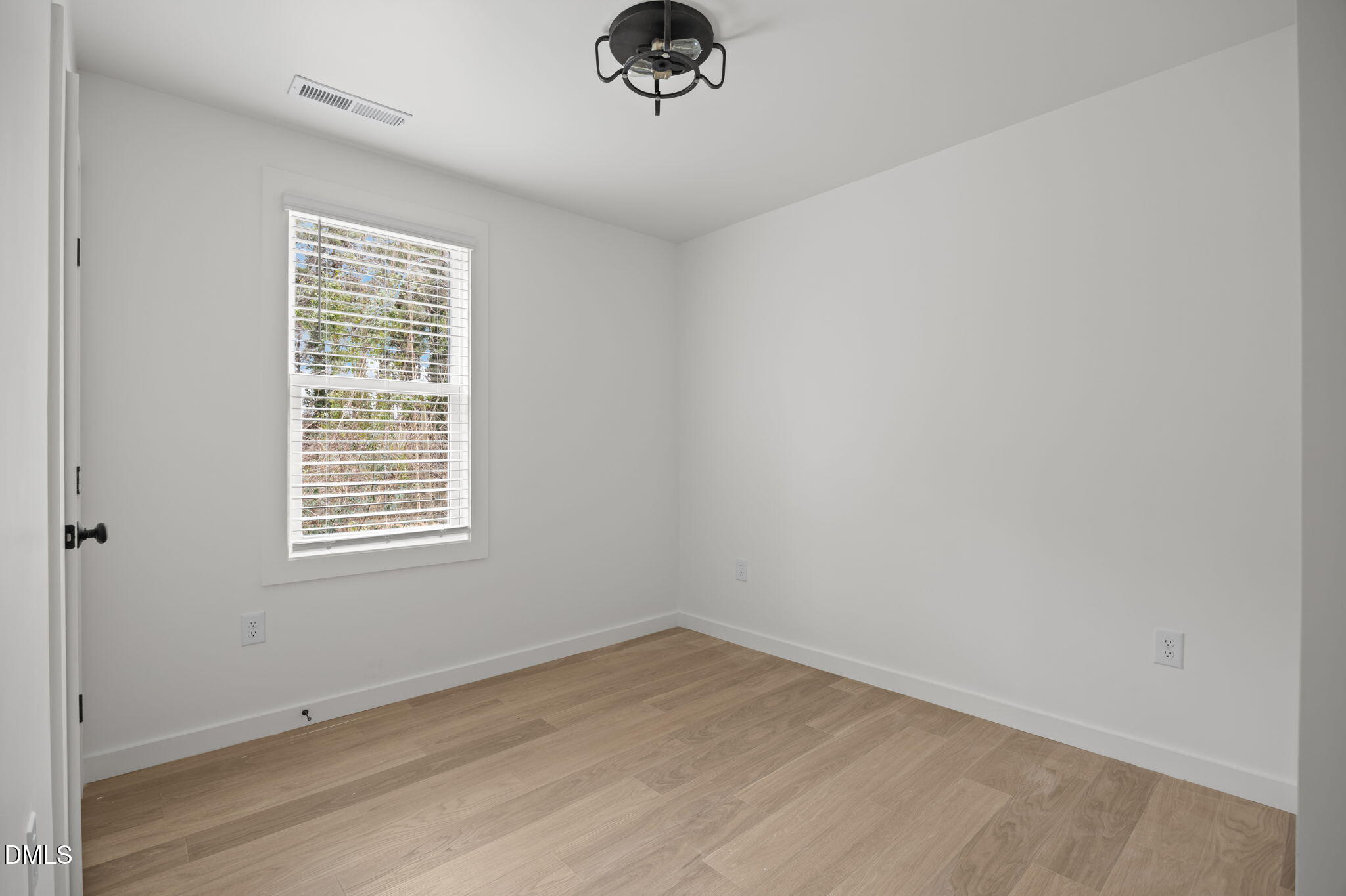 2811 Wilcox Street, Unit 103 Raleigh, NC 27607 - Photo 3 of 17 an empty room with a empty space and a window