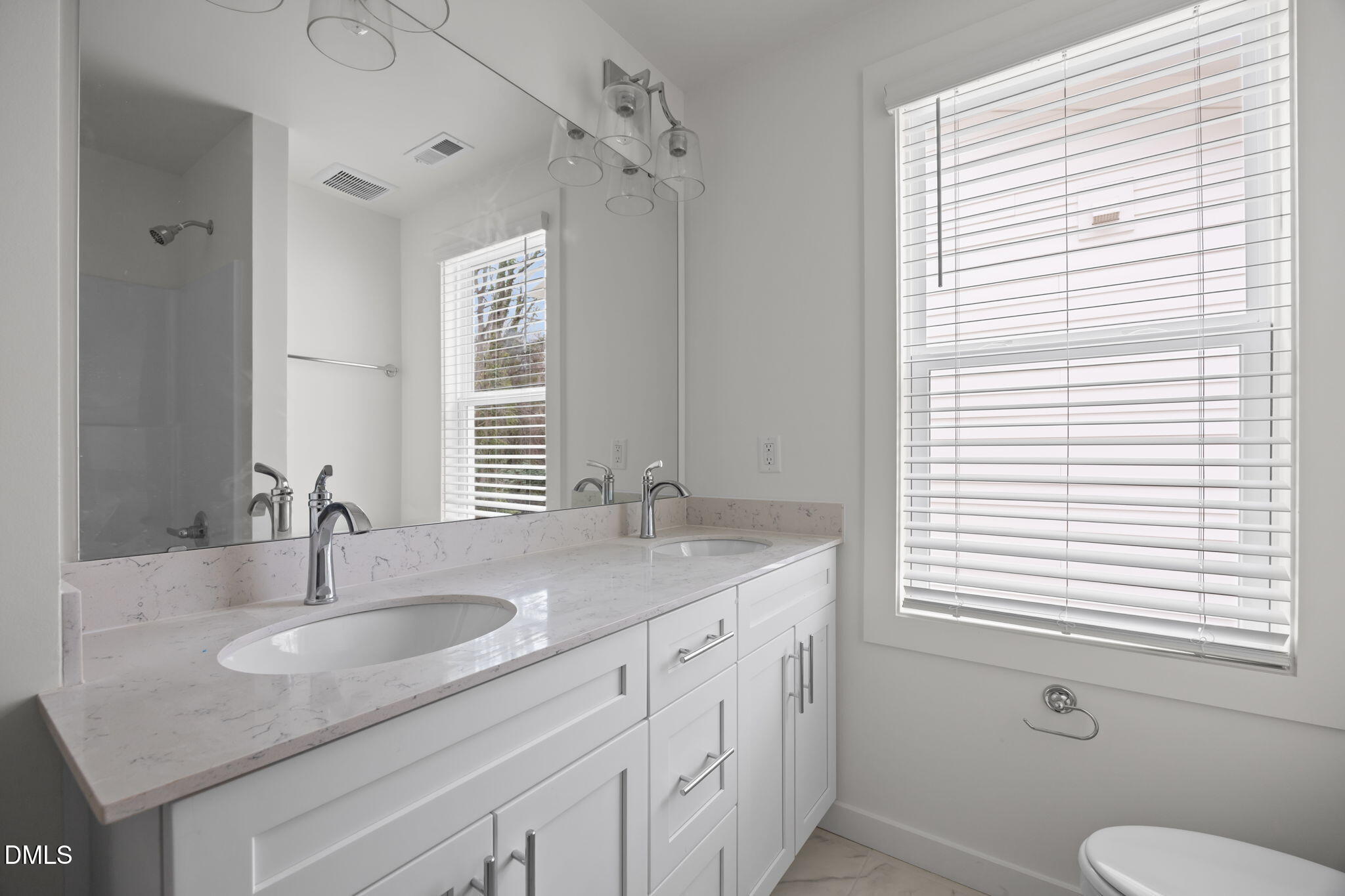 2811 Wilcox Street, Unit 103 Raleigh, NC 27607 - Photo 4 of 17 a bathroom with double sink and a window