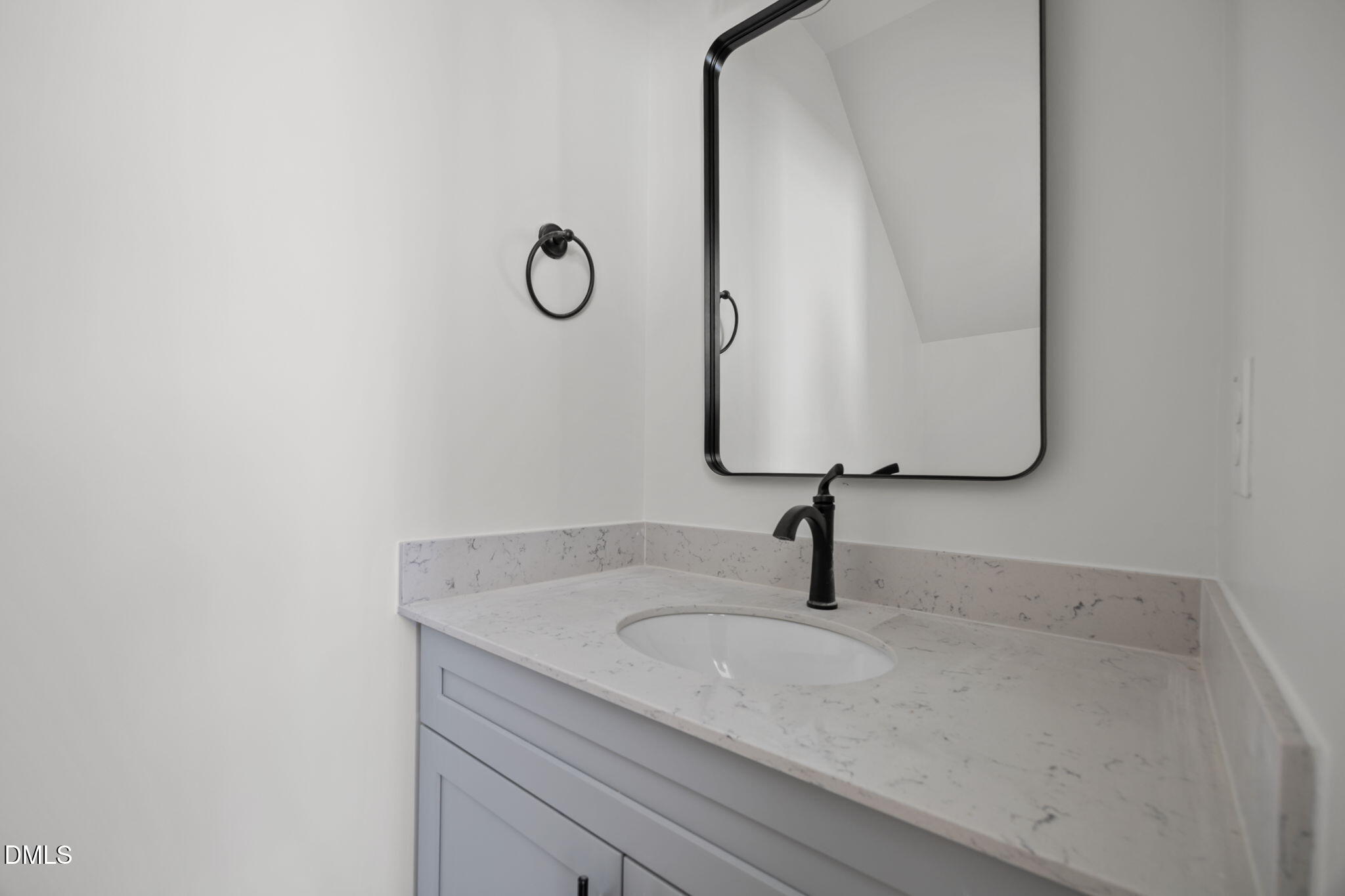 2811 Wilcox Street, Unit 103 Raleigh, NC 27607 - Photo 5 of 17 a bathroom with a sink and mirror