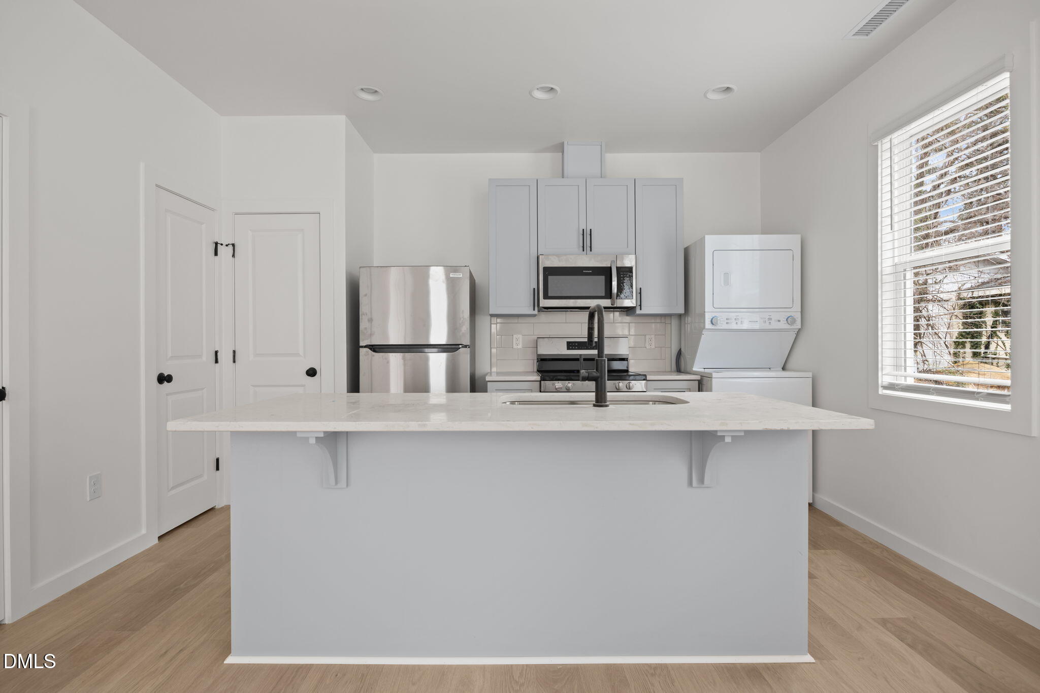 2811 Wilcox Street, Unit 103 Raleigh, NC 27607 - Photo 6 of 17 a kitchen with stainless steel appliances a sink a stove a refrigerator and cabinets
