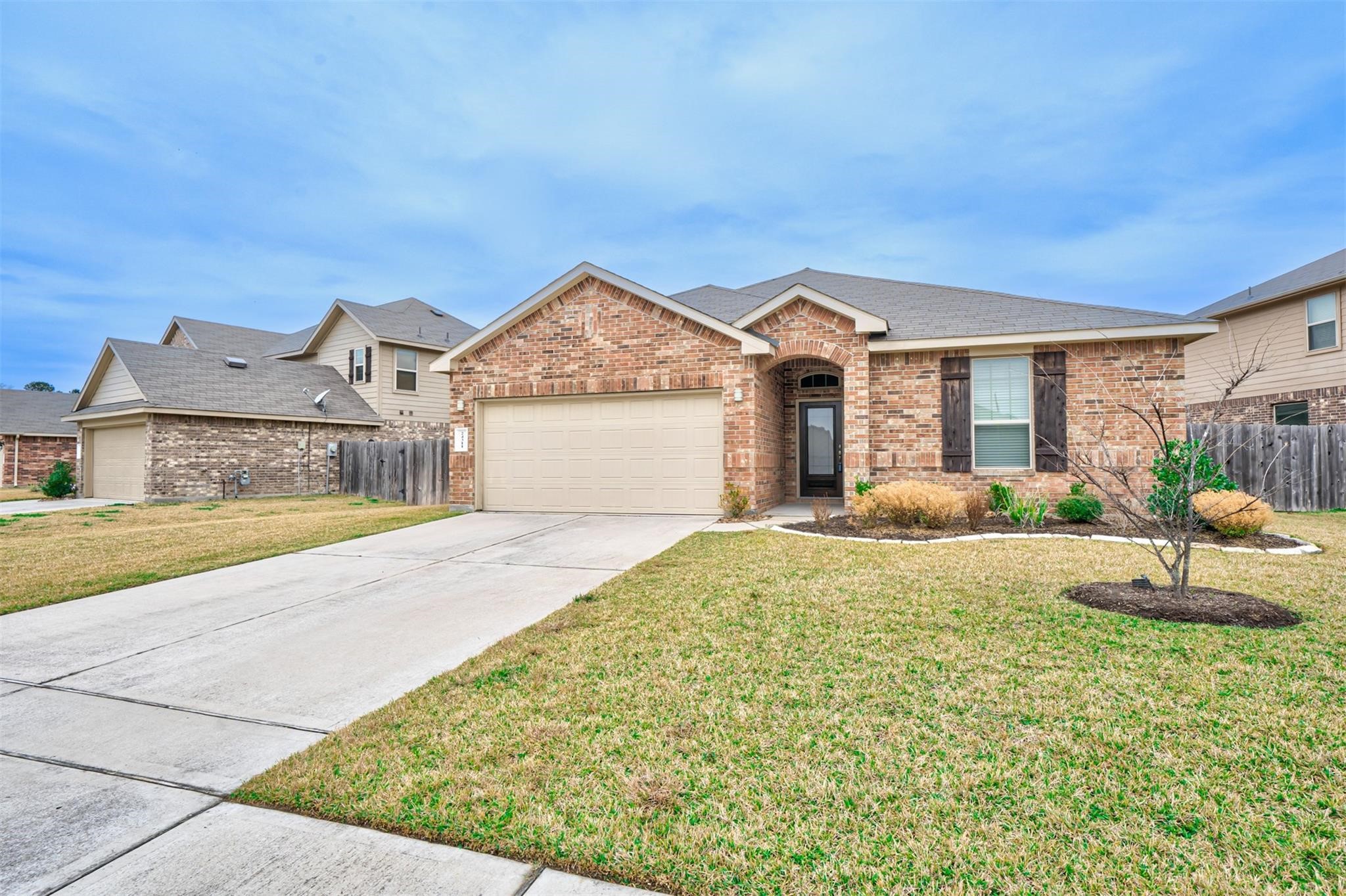 24311 North Newcastle Bay Trail Spring, TX 77389 - Photo 1 of 25 a front view of a house with a yard