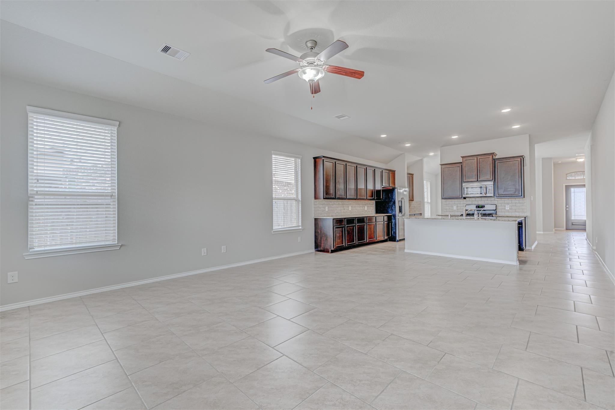 24311 North Newcastle Bay Trail Spring, TX 77389 - Photo 12 of 25 a view of kitchen and window with fireplace