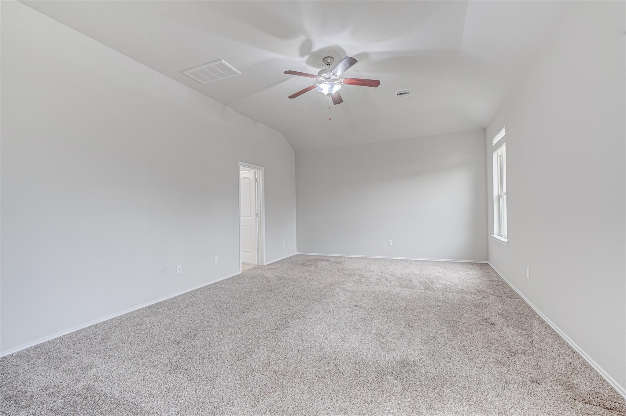 24311 North Newcastle Bay Trail Spring, TX 77389 - Photo 14 of 25 a view of an empty room with a ceiling fan and window