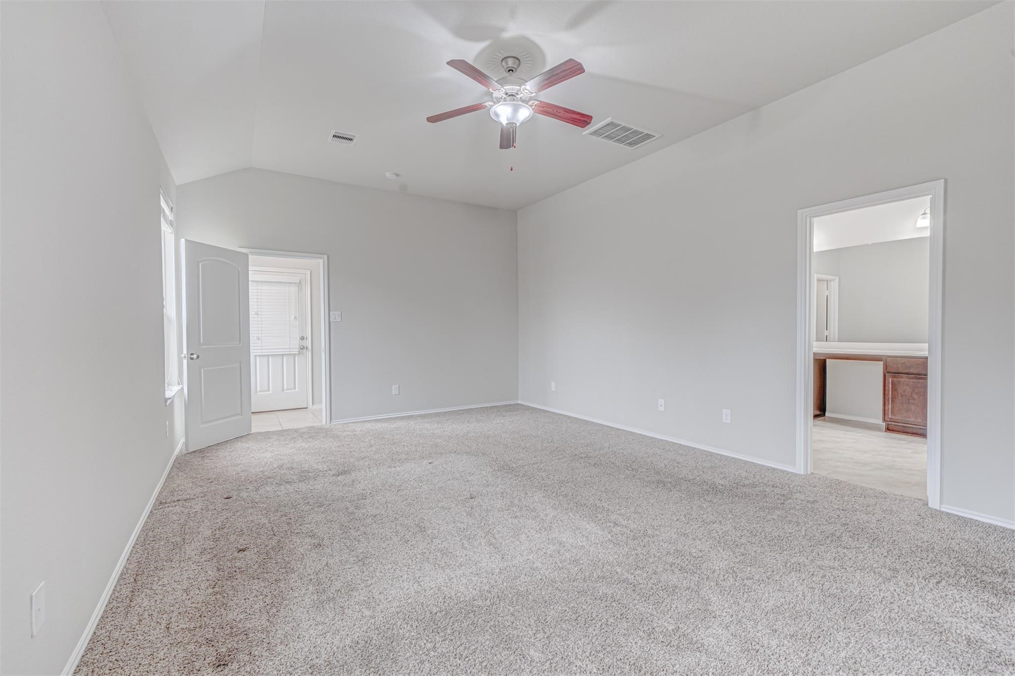 24311 North Newcastle Bay Trail Spring, TX 77389 - Photo 15 of 25 a view of an empty room with a ceiling fan