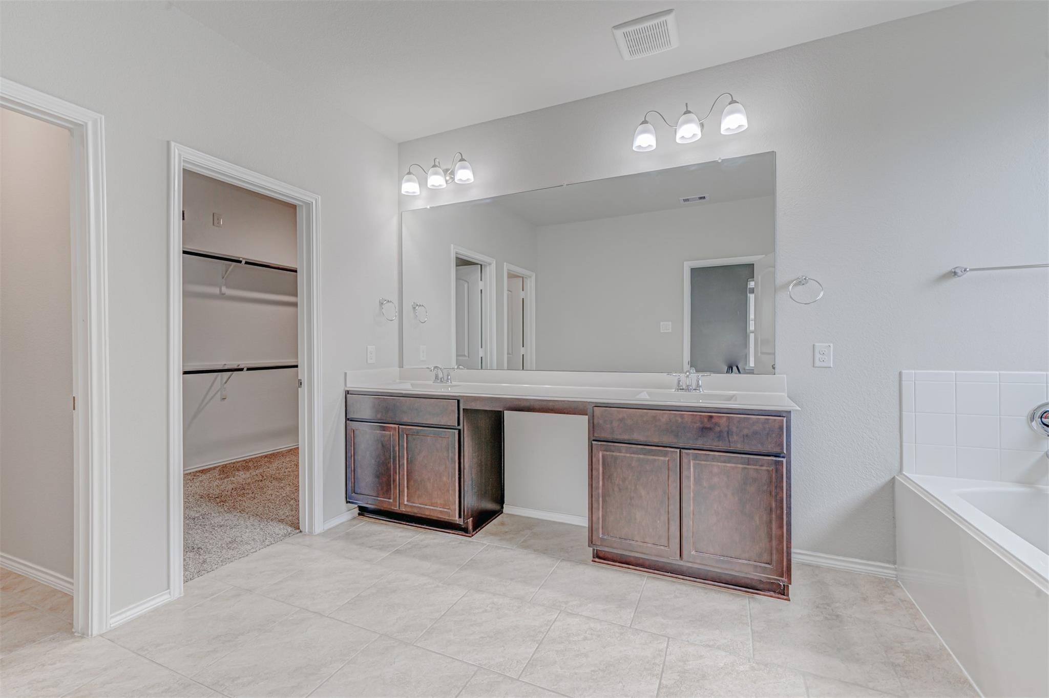 24311 North Newcastle Bay Trail Spring, TX 77389 - Photo 16 of 25 a bathroom with a granite countertop sink mirror and bathtub