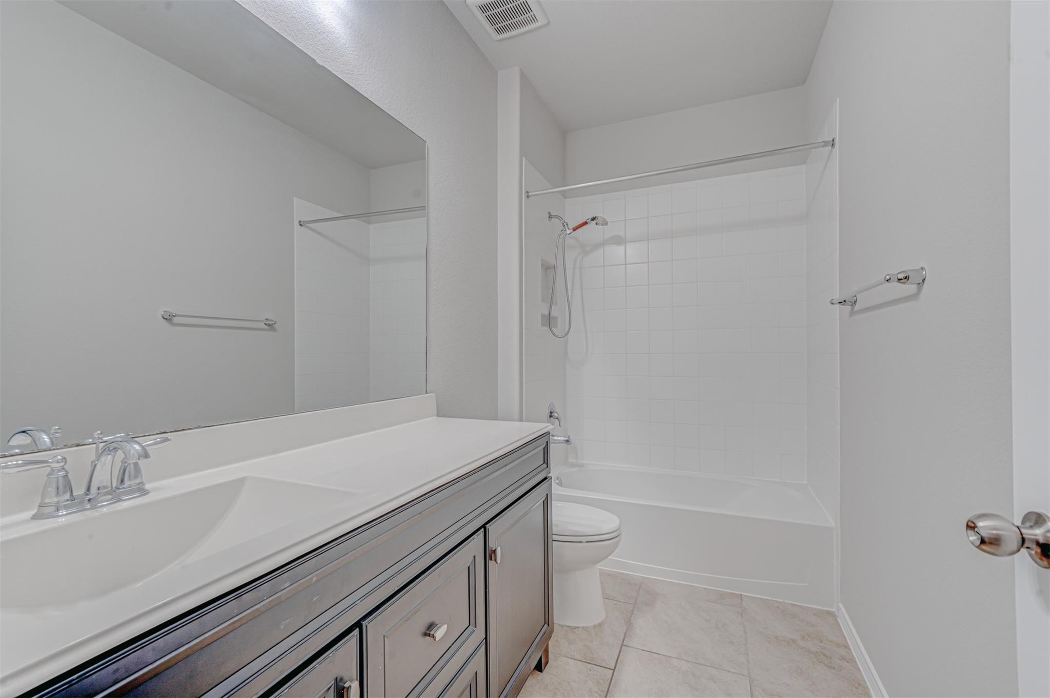 24311 North Newcastle Bay Trail Spring, TX 77389 - Photo 20 of 25 a bathroom with a sink a toilet and shower