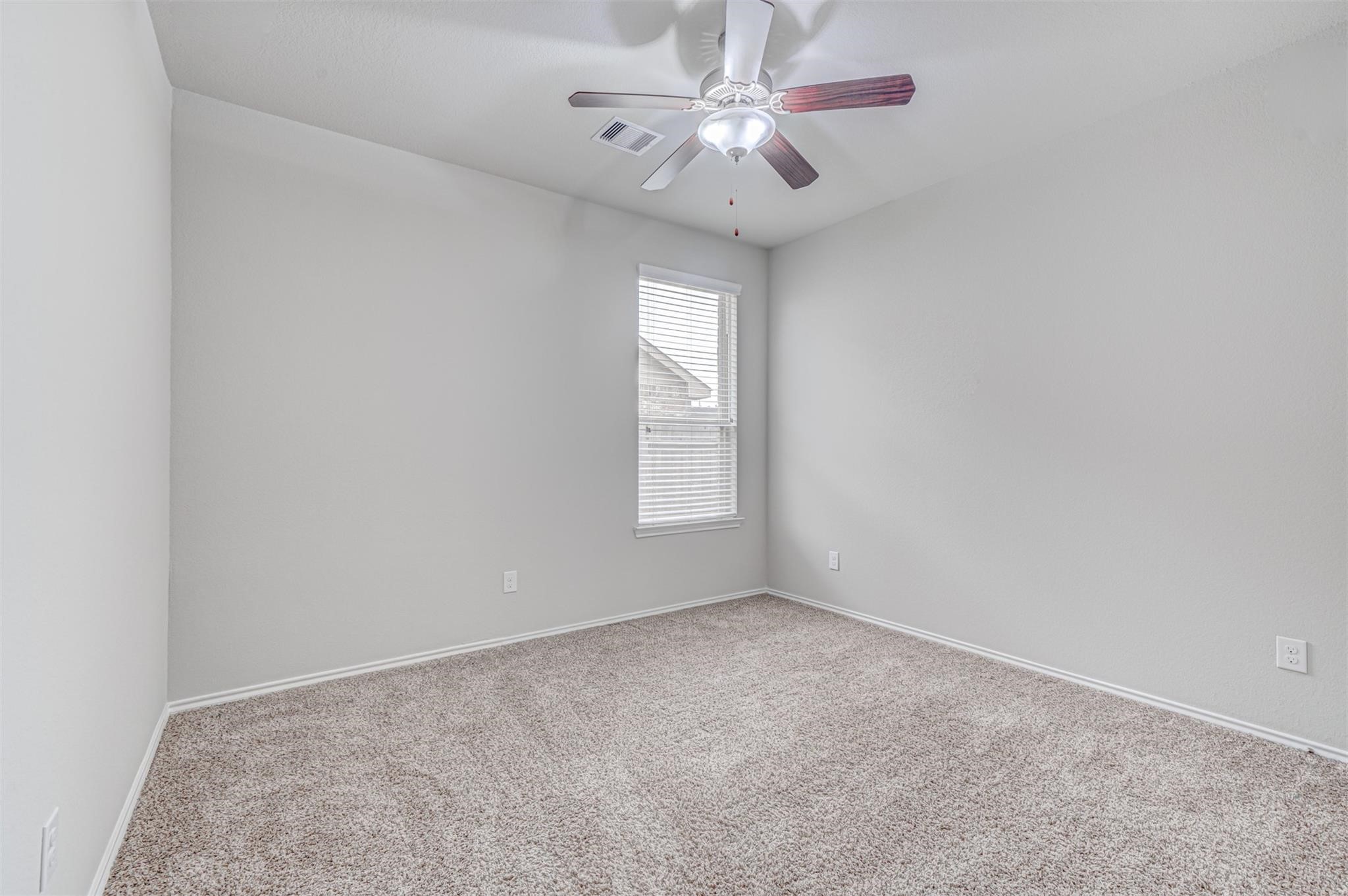 24311 North Newcastle Bay Trail Spring, TX 77389 - Photo 21 of 25 an empty room with windows and fan