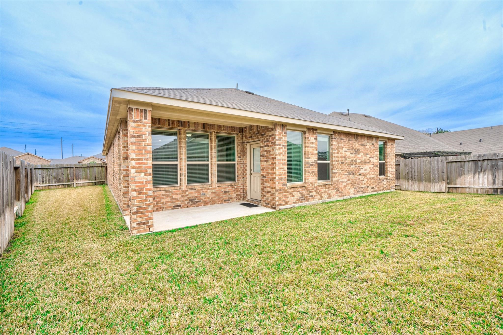 24311 North Newcastle Bay Trail Spring, TX 77389 - Photo 24 of 25 a view of a house with a backyard