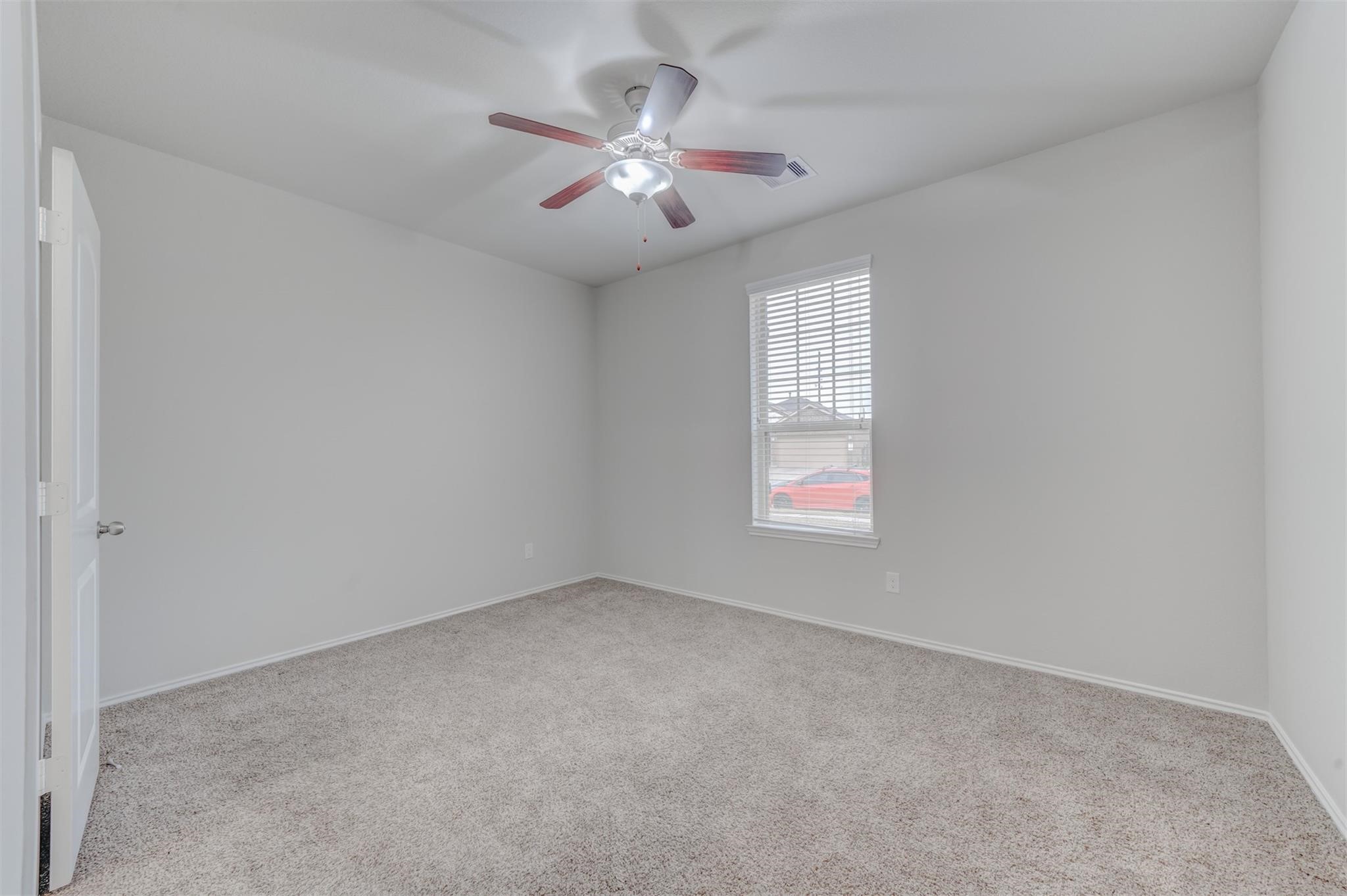 24311 North Newcastle Bay Trail Spring, TX 77389 - Photo 3 of 25 an empty room with a chandelier fan and windows