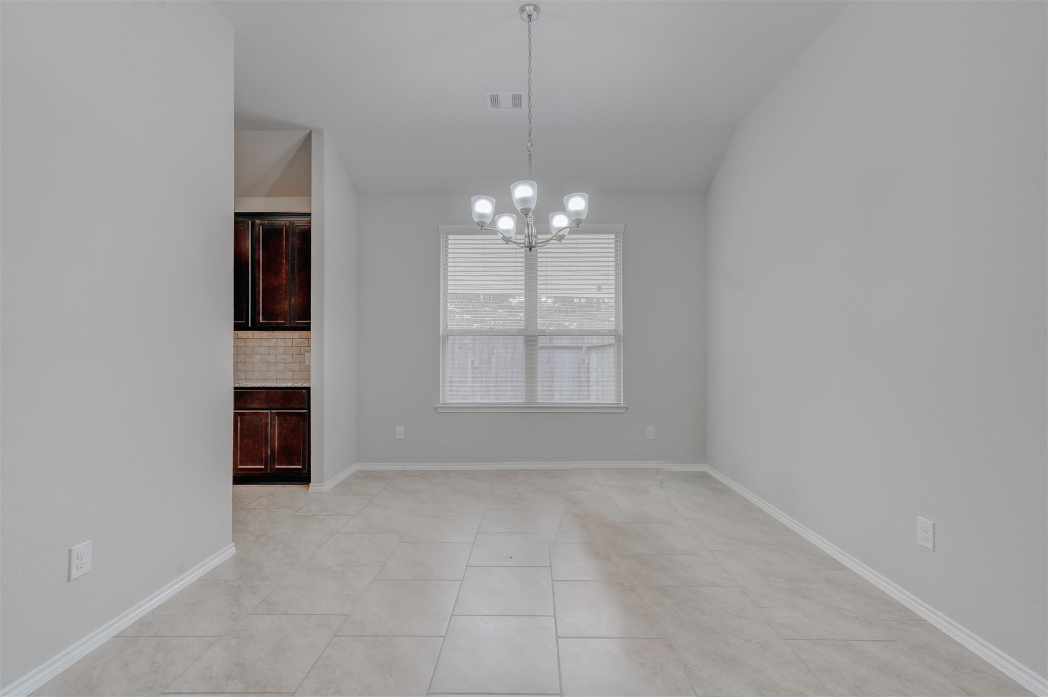 24311 North Newcastle Bay Trail Spring, TX 77389 - Photo 5 of 25 a view of an empty room with window and chandelier fan