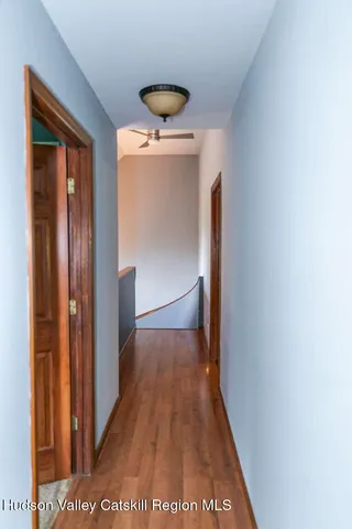 a view of hallway with wooden floor