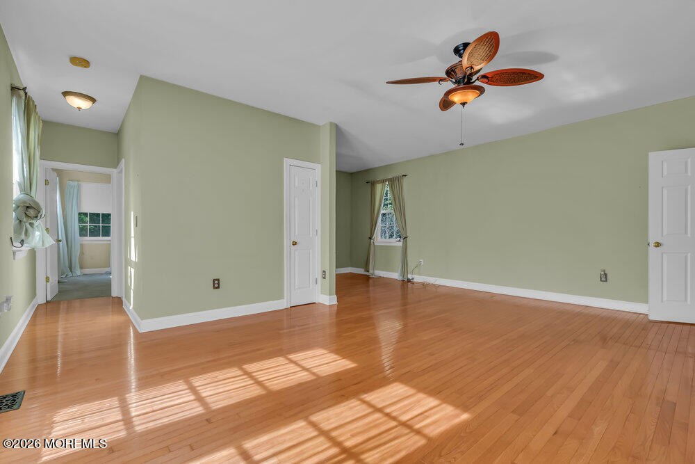 10 Meadow Run Court Jackson, NJ 08527 - Photo 29 of 84 a view of a livingroom with wooden floor and a ceiling fan