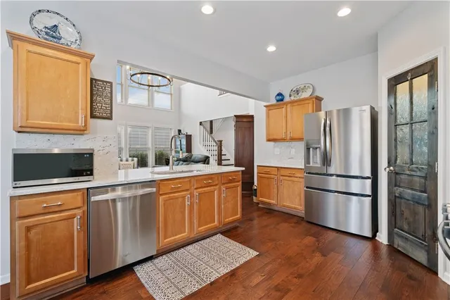a kitchen with stainless steel appliances a refrigerator sink and cabinets