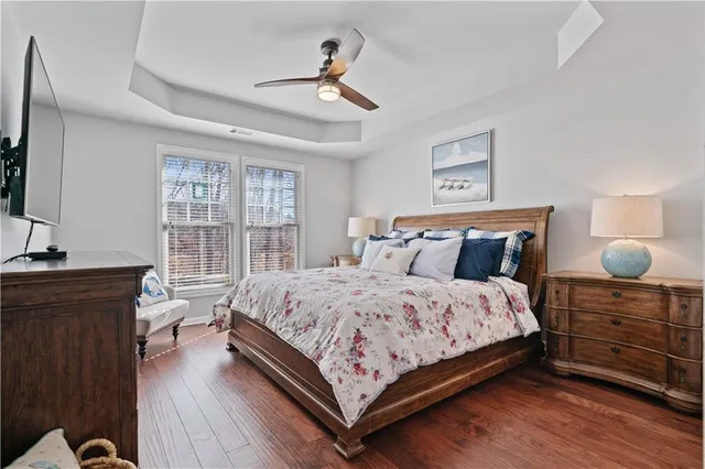 a bedroom with bed and wooden floor
