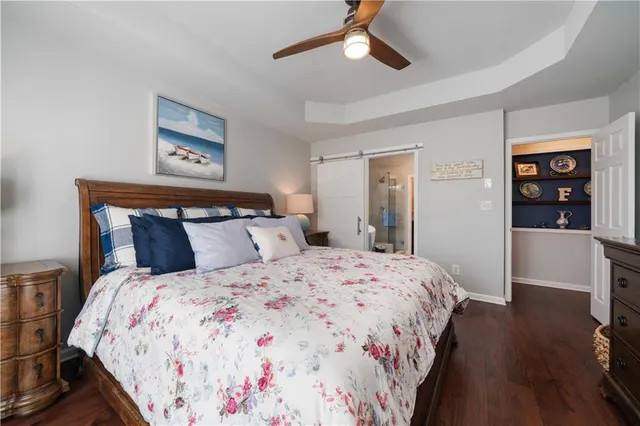 a bedroom with bed and wooden floor