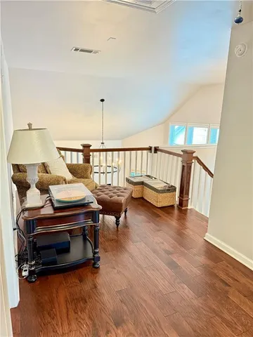 a living room with furniture a table and wooden floor