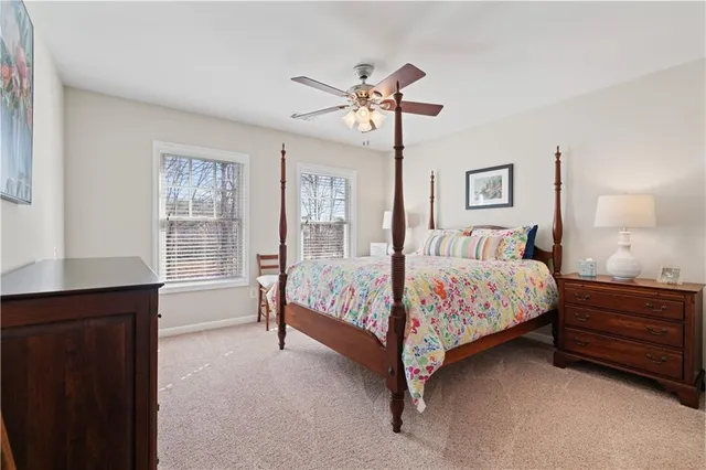 a bedroom with a bed chandelier and a window