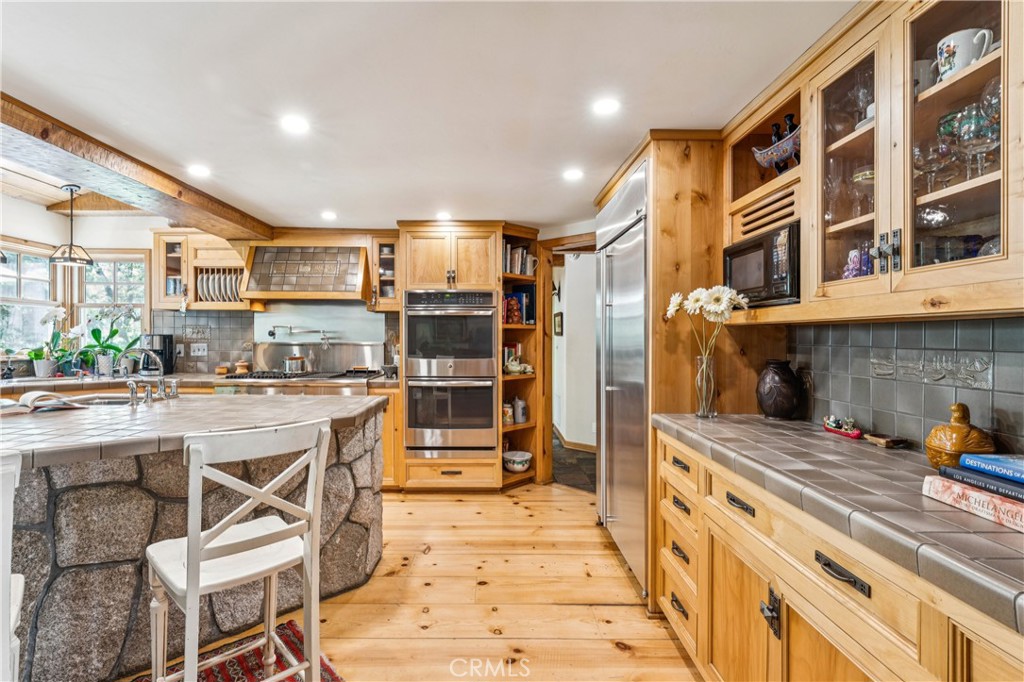 28971 North Shore Road Lake Arrowhead, CA 92352 - Photo 19 of 60 a kitchen with a sink and cabinets