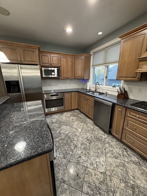 196 Country Club Way Ipswich, MA 01938 - Photo 14 of 33 a kitchen with stainless steel appliances granite countertop a sink stove and refrigerator