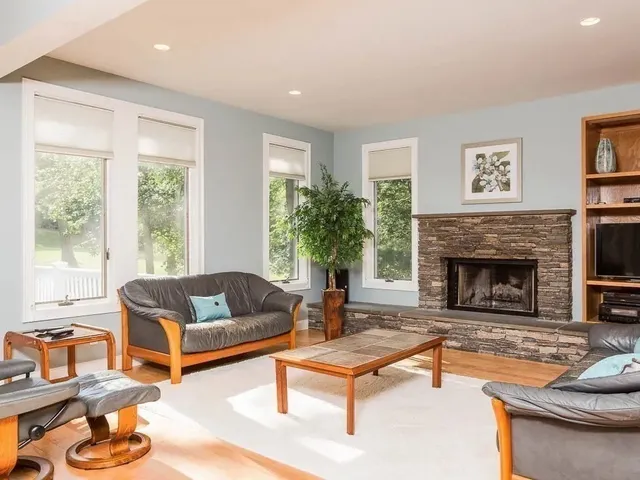 a living room with furniture and a fireplace