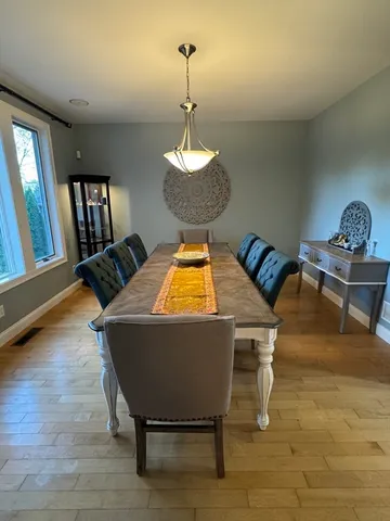 a dining room with furniture and window