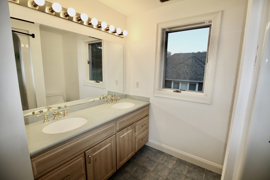 196 Country Club Way Ipswich, MA 01938 - Photo 22 of 33 a bathroom with a sink and a mirror
