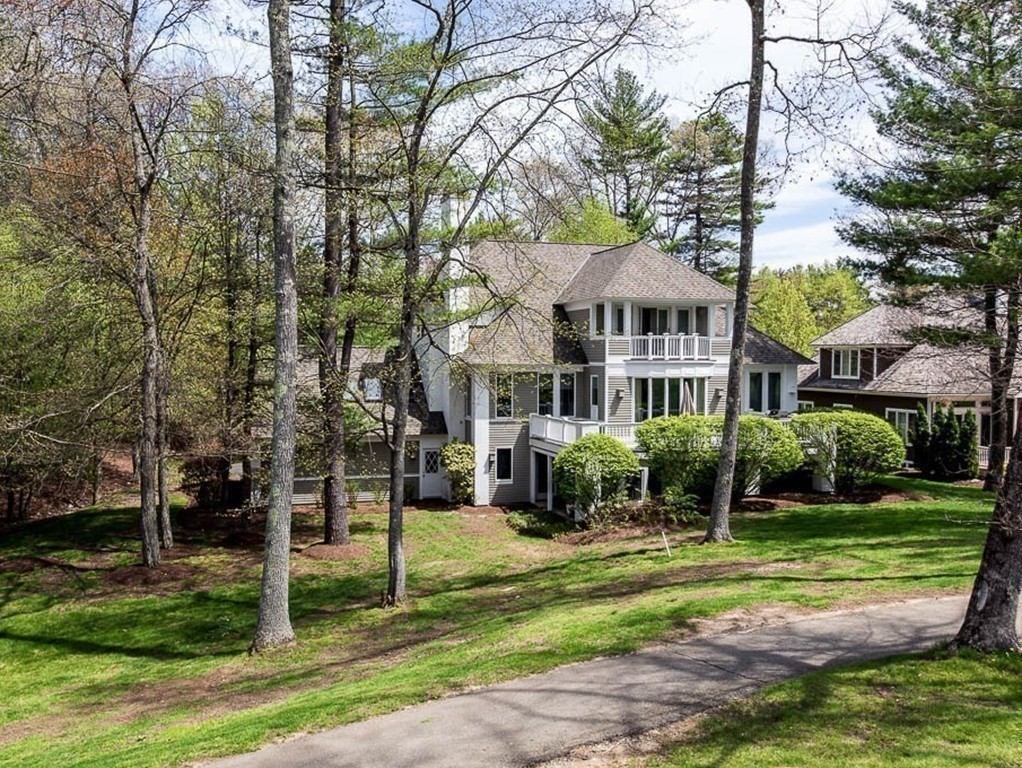 196 Country Club Way Ipswich, MA 01938 - Photo 3 of 33 a front view of a house with a yard table and chairs