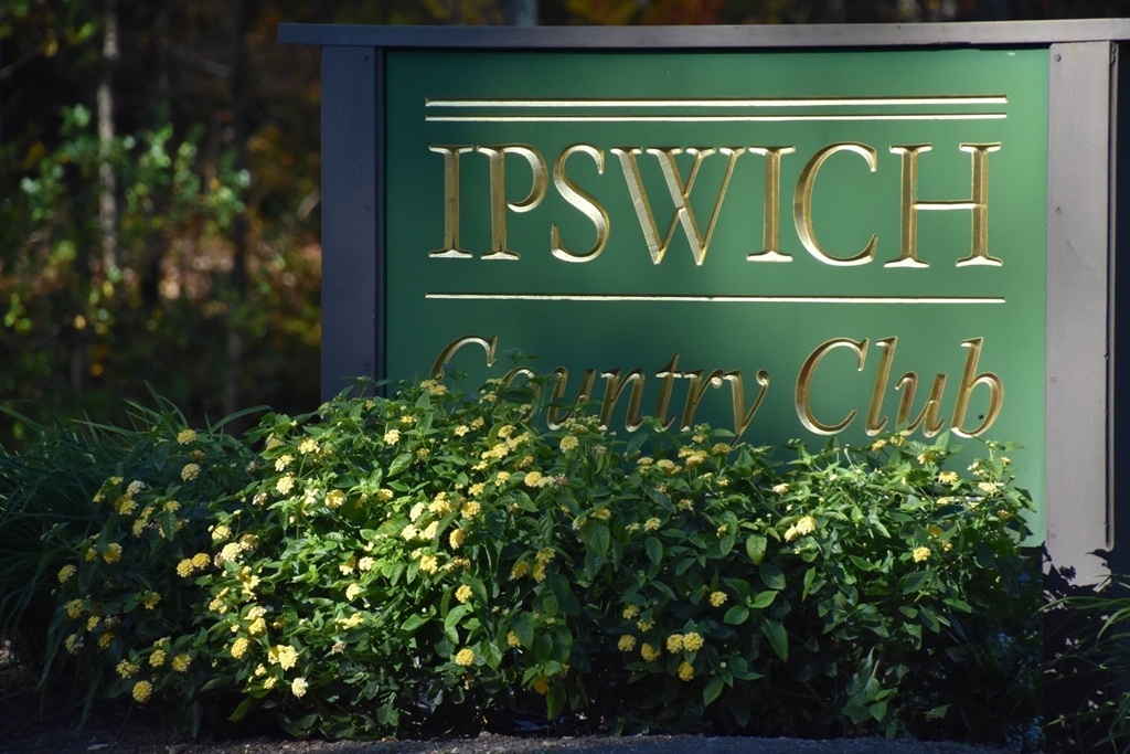 196 Country Club Way Ipswich, MA 01938 - Photo 8 of 33 a green sign that is on a wall