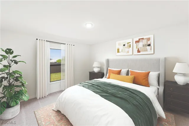 a bedroom with a large bed and a potted plant