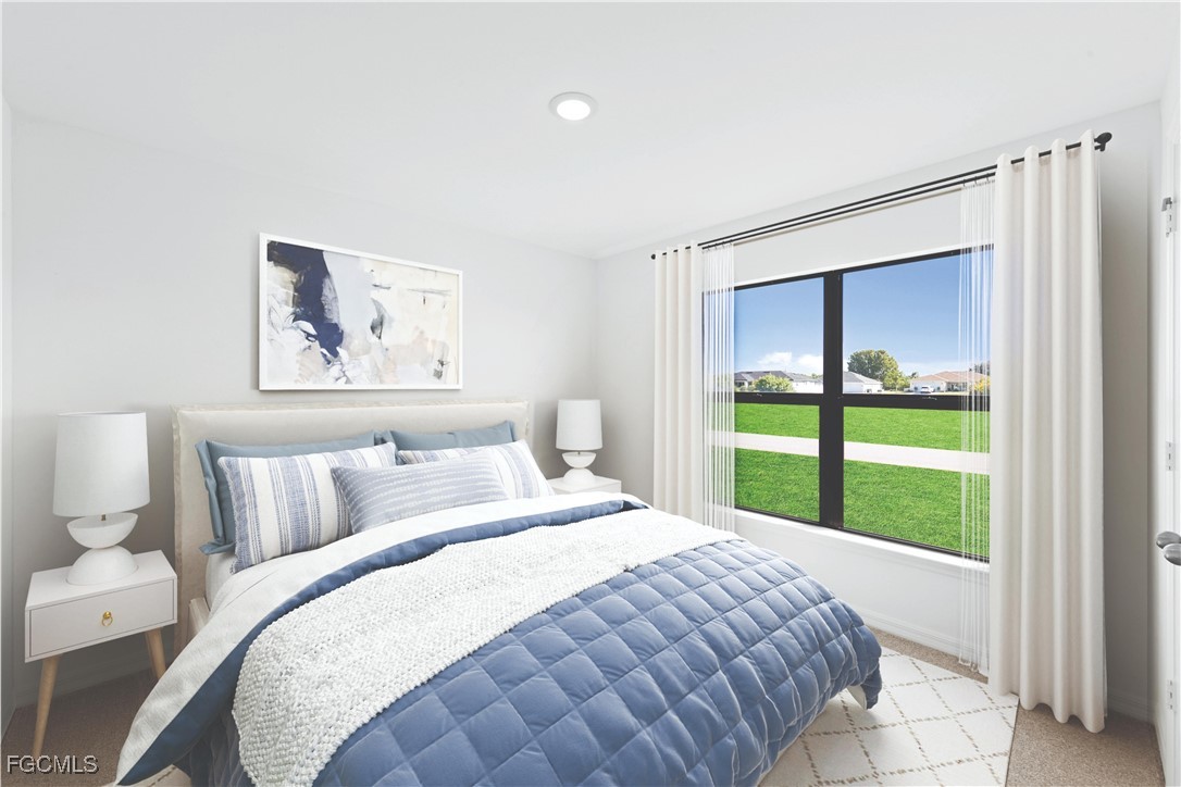 1219 Ecclus Street East Lehigh Acres, FL 33974 - Photo 6 of 8 a bedroom with a bed and a painting on the wall