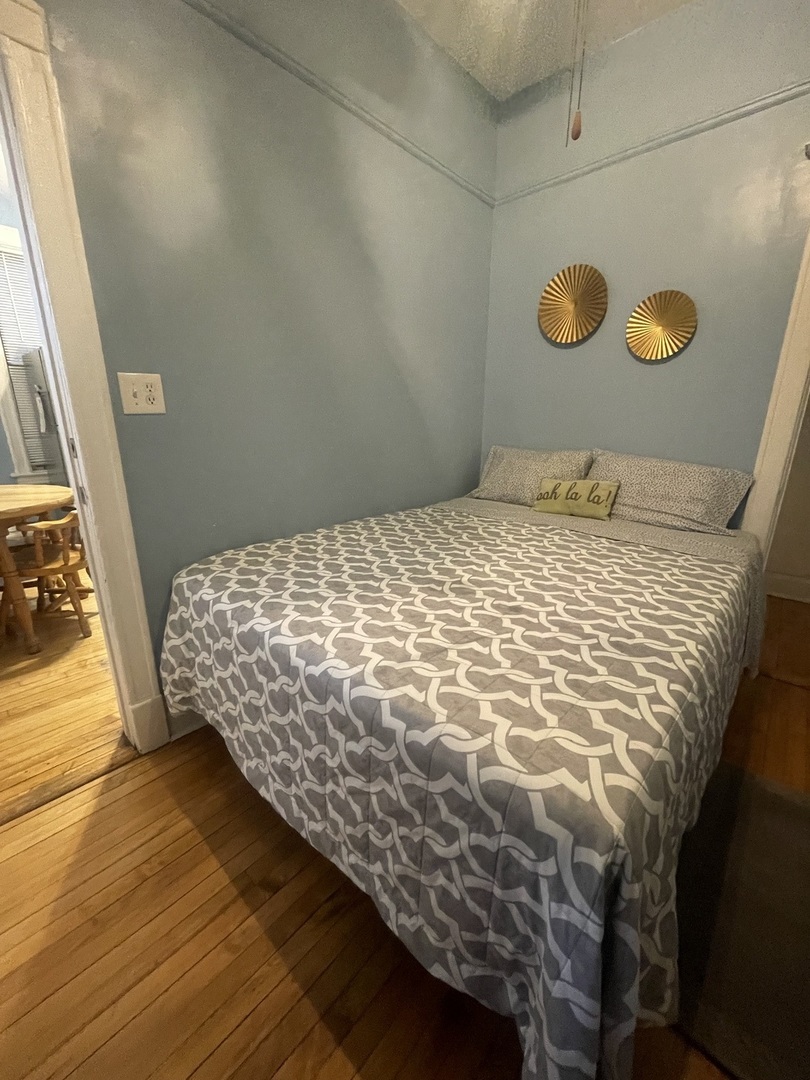 2107 West Coulter Street, Unit 1R Chicago, IL 60608 - Photo 12 of 26 a bedroom with a bed and a window