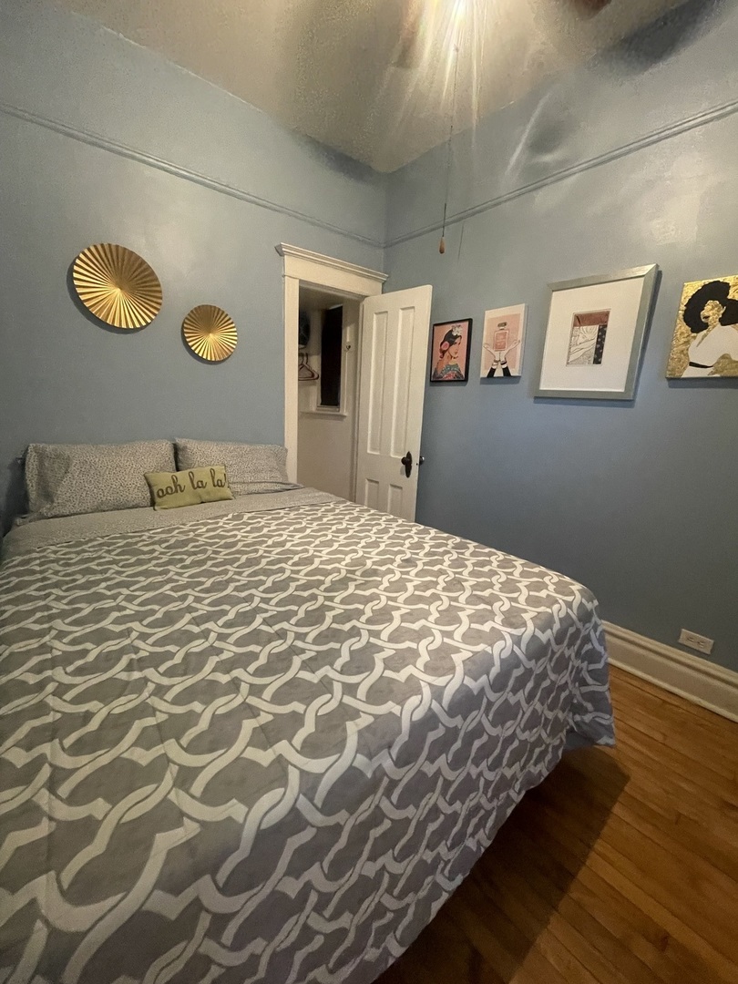 2107 West Coulter Street, Unit 1R Chicago, IL 60608 - Photo 13 of 26 a bedroom with a bed and a painting on the wall