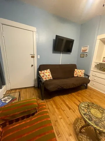 a living room with a couch and a flat screen tv