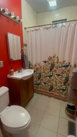 a bathroom with a toilet sink and shower