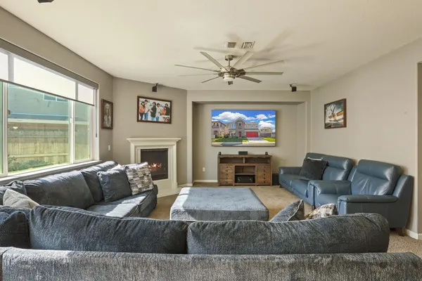 a living room with fireplace furniture and a flat screen tv