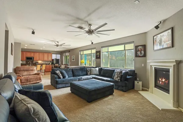 a living room with furniture fireplace and a large window